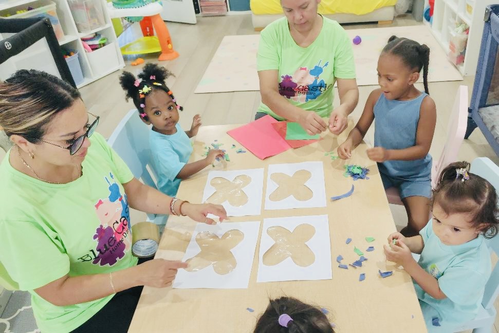 Teachers and children doing an arts and crafts activity